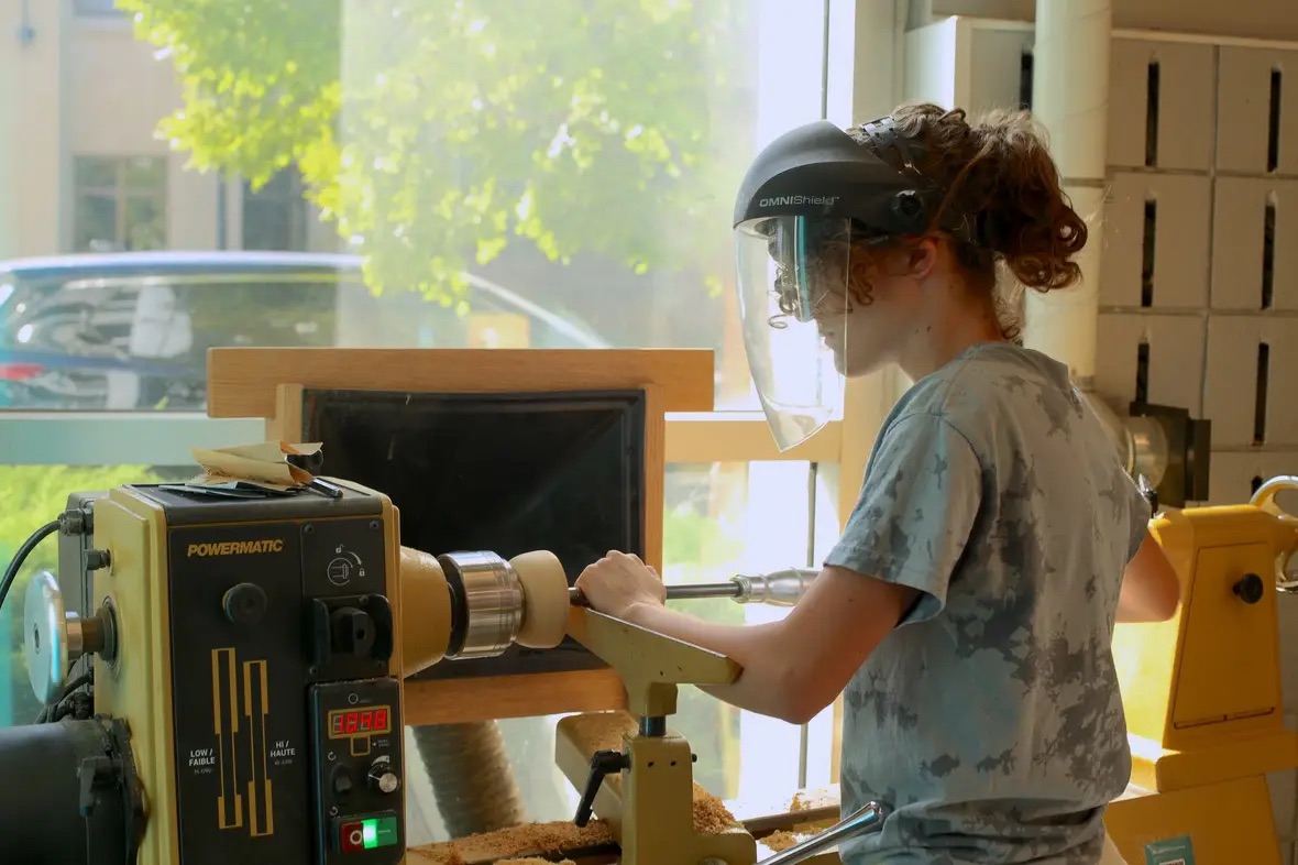 Working on a bowl on a lathe.